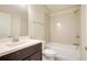 A well-lit bathroom features a vanity, toilet, and shower-tub combo with white subway tile at 1949 Townsend Ne Ct # 22, Atlanta, GA 30329