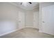 A carpeted bedroom featuring a ceiling fan and multiple closet doors at 1949 Townsend Ne Ct # 22, Atlanta, GA 30329