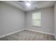 Bedroom featuring gray carpet, a ceiling fan, and a window with wooded scenery at 1949 Townsend Ne Ct # 22, Atlanta, GA 30329