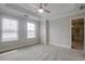 Carpeted bedroom with two windows, ceiling fan and light, and access to an en suite bathroom at 1949 Townsend Ne Ct # 22, Atlanta, GA 30329