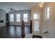Light-filled entryway with dark hardwood floors, staircase and view to the living room at 1949 Townsend Ne Ct # 22, Atlanta, GA 30329