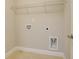 Bright laundry room with tile flooring, storage shelf, and utility hookups at 1949 Townsend Ne Ct # 22, Atlanta, GA 30329