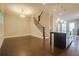 Living room with hardwood floors next to kitchen with island and staircase at 1949 Townsend Ne Ct # 22, Atlanta, GA 30329