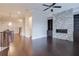Bright living room features a stone fireplace, dark hardwood floors and a ceiling fan at 1949 Townsend Ne Ct # 22, Atlanta, GA 30329