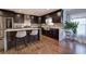 Updated kitchen with dark wood cabinets, marble counters, and stainless steel appliances at 52 Buena Vista Se Cir, Cartersville, GA 30121