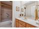 Bright bathroom with a tiled shower and tub, large mirror over vanity, and a neutral color palette at 11880 Wexford Club Dr, Roswell, GA 30075
