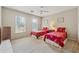 Bright bedroom featuring two twin beds, neutral walls, carpet and a ceiling fan for comfort at 11880 Wexford Club Dr, Roswell, GA 30075