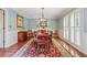 Elegant dining room with hardwood floors, wainscoting, and a stylish chandelier at 11880 Wexford Club Dr, Roswell, GA 30075