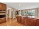 Spacious kitchen featuring a built-in microwave, stainless steel appliances, and an island cooktop at 11880 Wexford Club Dr, Roswell, GA 30075