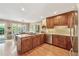 Well-appointed kitchen featuring an island with a cooktop, stainless steel appliances, and custom cabinetry at 11880 Wexford Club Dr, Roswell, GA 30075