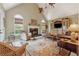 Inviting living room with a fireplace, high ceilings, and large windows for natural light at 11880 Wexford Club Dr, Roswell, GA 30075