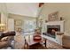 Bright living room featuring a fireplace, comfortable seating, and a vaulted ceiling at 11880 Wexford Club Dr, Roswell, GA 30075