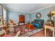 Cozy living room featuring a comfortable blue sofa, hardwood floors, and natural light at 11880 Wexford Club Dr, Roswell, GA 30075