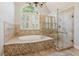 Elegant bathroom with a soaking tub, glass shower, and neutral tiles for a calming experience at 11880 Wexford Club Dr, Roswell, GA 30075