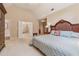 Inviting main bedroom featuring a vaulted ceiling, plush carpet, and doorway to a well-appointed bathroom at 11880 Wexford Club Dr, Roswell, GA 30075