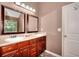 Bathroom vanity featuring double sinks, framed mirrors, wooden cabinets and updated lighting at 2314 Robin Dr, Loganville, GA 30052