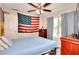 Bedroom with ceiling fan, dresser, neutral paint and large window offering natural light at 2314 Robin Dr, Loganville, GA 30052