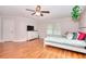 Spacious bedroom featuring wood laminate floors, ceiling fan and natural light with attached ensuite at 2314 Robin Dr, Loganville, GA 30052