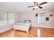 Bedroom with ceiling fan, wood laminate floors, large window and neutral paint at 2314 Robin Dr, Loganville, GA 30052