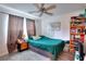 Comfortable bedroom showcasing a ceiling fan, wood floors, and a shelving unit at 2314 Robin Dr, Loganville, GA 30052