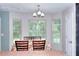 Bright dining area with a bay window, complemented by wood floors, and simple decor at 2314 Robin Dr, Loganville, GA 30052