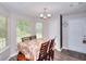 Cozy dining area featuring natural light, a chandelier and floral tablecloth creating an inviting atmosphere at 2314 Robin Dr, Loganville, GA 30052