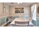 Comfortable dining room boasts soft lighting, wainscoting, and tasteful wall art at 2314 Robin Dr, Loganville, GA 30052