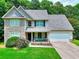 Charming two-story home with stone facade, manicured lawn, and inviting front porch at 2314 Robin Dr, Loganville, GA 30052