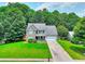 Inviting home with a manicured lawn, mature trees, and a welcoming front porch at 2314 Robin Dr, Loganville, GA 30052