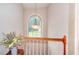 Bright hallway featuring natural light through arched window and an elegant hanging light fixture at 2314 Robin Dr, Loganville, GA 30052