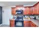 Kitchen with black appliances, ample counter space, and mosaic tile backsplash at 2314 Robin Dr, Loganville, GA 30052