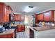Well-equipped kitchen with dark cabinetry, stainless steel appliances, and mosaic backsplash at 2314 Robin Dr, Loganville, GA 30052