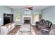 Spacious living room featuring a stone fireplace, large TV, and comfortable seating at 2314 Robin Dr, Loganville, GA 30052