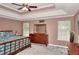 Spacious main bedroom with a tray ceiling, large windows, and stylish furnishings at 2314 Robin Dr, Loganville, GA 30052