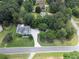 Overhead view of home featuring manicured lawn and mature trees with detached garage at 100 Chestnut Hill Dr, Canton, GA 30114
