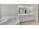 Bathroom with a soaking tub, double sink vanity, and tile flooring at 100 Chestnut Hill Dr, Canton, GA 30114