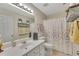 Bright bathroom with a single sink vanity, shower, and neutral decor at 100 Chestnut Hill Dr, Canton, GA 30114