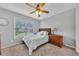 Cozy bedroom featuring plush carpet, a ceiling fan, and a window view at 100 Chestnut Hill Dr, Canton, GA 30114