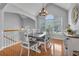 Elegant dining room with wood floors, modern chandelier, and vaulted ceilings at 100 Chestnut Hill Dr, Canton, GA 30114