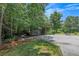 Large paved driveway surrounded by mature trees and lush greenery offers ample parking at 100 Chestnut Hill Dr, Canton, GA 30114