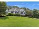 Well-maintained home with lush green lawn and mature trees in a suburban setting at 100 Chestnut Hill Dr, Canton, GA 30114