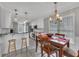 Spacious kitchen and dining area with wood table, island with seating, white cabinets and stainless appliances at 100 Chestnut Hill Dr, Canton, GA 30114