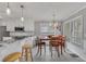 Bright kitchen and dining area with wood table, island with seating, white cabinets and stainless appliances at 100 Chestnut Hill Dr, Canton, GA 30114
