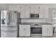 Kitchen features include stainless steel appliances, granite countertops, and white subway tile backsplash at 100 Chestnut Hill Dr, Canton, GA 30114