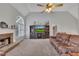 Open living room with fireplace, high ceilings and a large entertainment center at 100 Chestnut Hill Dr, Canton, GA 30114