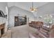 Inviting living room with fireplace, high ceilings, and neutral carpet flooring at 100 Chestnut Hill Dr, Canton, GA 30114