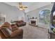 Bright living room featuring a fireplace, hardwood floors, and large windows at 100 Chestnut Hill Dr, Canton, GA 30114