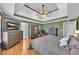 Large main bedroom featuring a tray ceiling, fan, and wood flooring at 100 Chestnut Hill Dr, Canton, GA 30114