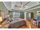 Main bedroom suite features a tray ceiling, fan, and wood flooring at 100 Chestnut Hill Dr, Canton, GA 30114