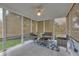 Relaxing sunroom with tiled floors and floor-to-ceiling screens at 100 Chestnut Hill Dr, Canton, GA 30114